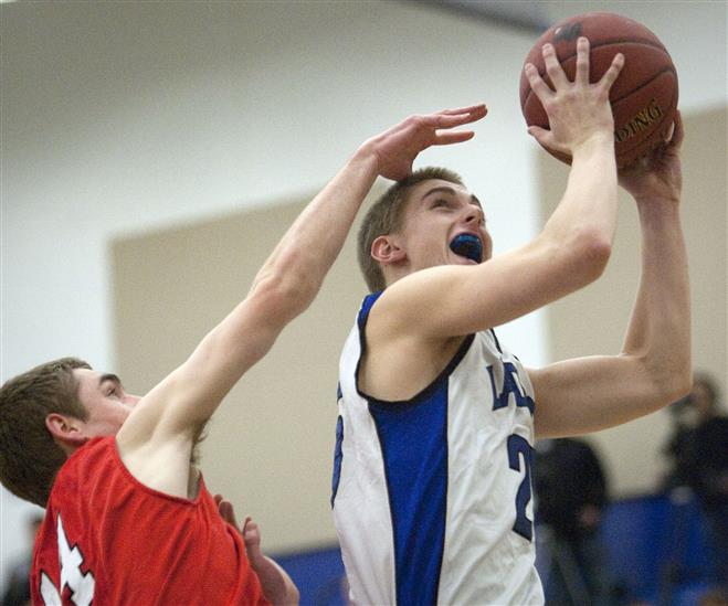 Brookfield Central's Riley LaChance goes to the basket in front of Wauwatosa East's Ben Mihelich.
