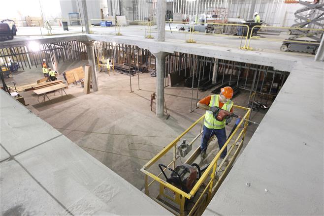 Hunzinger Construction employee Sean Maher works in what will be the upper and lower corridors leading to the Nordstrom store at Mayfair Mall in Wauwatosa. The 140,000-square-foot department store, which will be Wisconsin’s first, is scheduled to open in fall 2015.