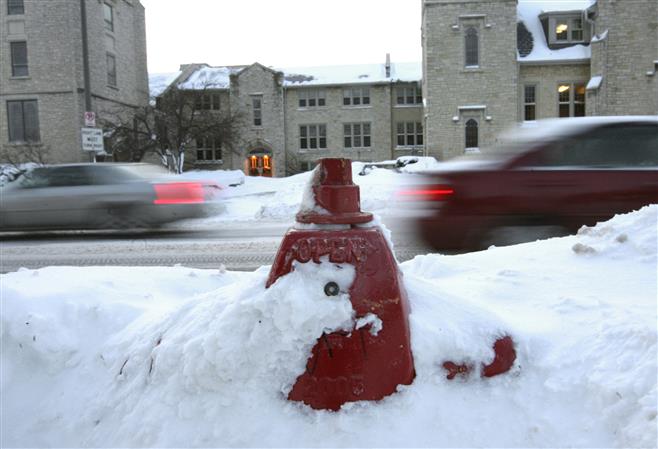 A fire hydrant on Wauwatosa Avenue is nearly covered with snow in 2008.