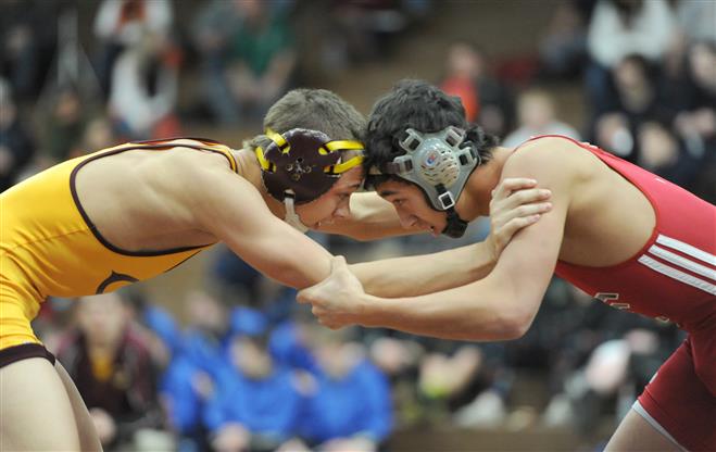 Kai Castaneda (right) competes with Tere White of West Allis Central in the finals of the Ed Stech tournament in December. Castaneda became Wauwatosa’s all-time winningest wrestler with his victories at the Hamilton Duals.