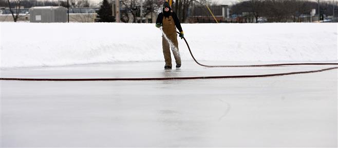 City of Wauwatosa Forestry Department employee Ruben Rivera adds a layer of water to the ice rink in Hart Park last week. The temperature at the noon hour in Wauwatosa was 10 degrees.