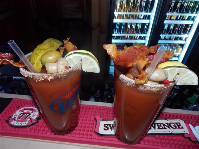 Even the bloody Mary’s come with bacon at Saloon on Calhoun with Bacon — bacon, and bacon-flavored vodka.