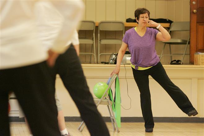Gloria Weckworth leads 15 students through an exercise class at the Hart Park Senior Center on Tuesday .