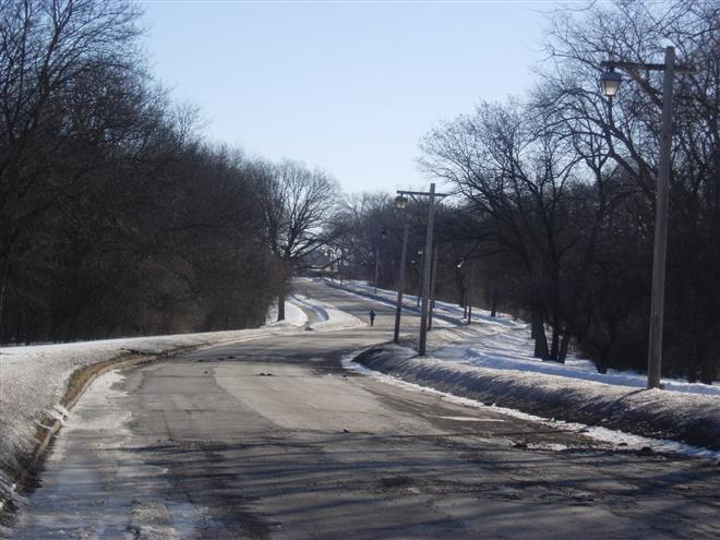 A lone runner is the only sign of life on Menomonee Parkway recently. The road had been closed because of deteriorating pavement.