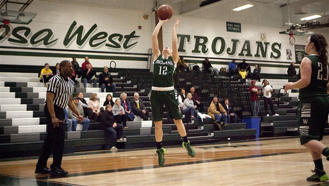 Wauwatosa West’s Emily Schaefer (12) goes up for a jumper as Brianna Colebourne (20) looks on against Millwaukee Madison.