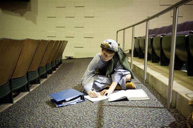 Wauwatosa West High School freshman Gabe Fisch, 15, studies Advanced Algebra 2 as he waits to rehearse his part as "Brother Dan" in a dress rehearsal of the school's musical "Joseph and the Amazing Technicolor Dreamcoat."