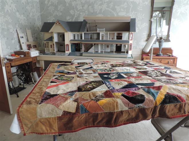 The Wauwatosa Historical Society is restoring this donated mid-19th century quilt for an exhibit scheduled in fall. The house in the background is a replica of a historic Church Street home.