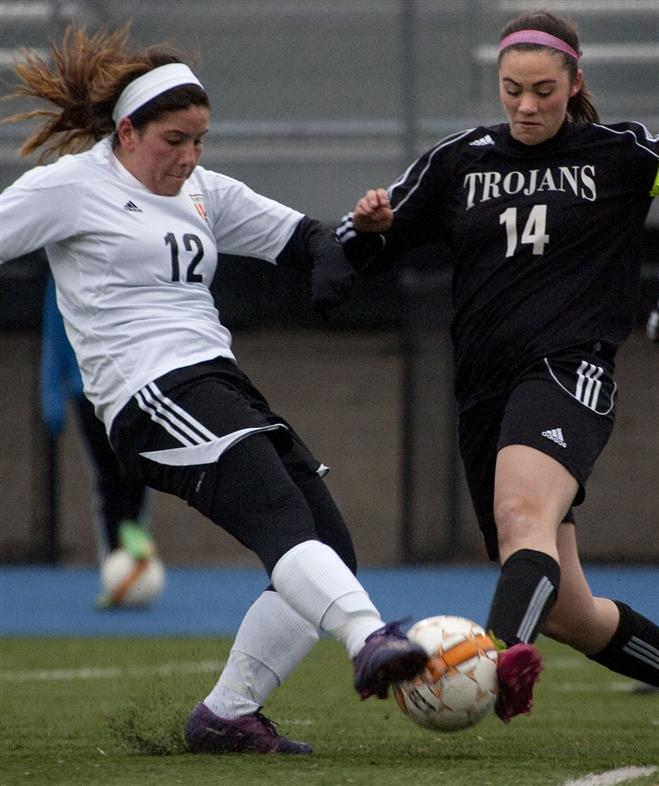 With a game-time temperature of 37 degrees, Hartford Union’s Hannah Peters (left) and Wauwatosa West’s Sarah Henson battle for control of the ball. The match ended in a 2-2 tie April 4 at Whitefish Bay.