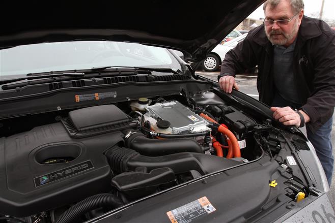 City of Wauwatosa's Lead Building Inspector Bill Mainus drives a Ford hybrid sedan that is part internal-combustion engine and part electric while out on appointments. The city is awaiting delivery of an all-electric vehicle.