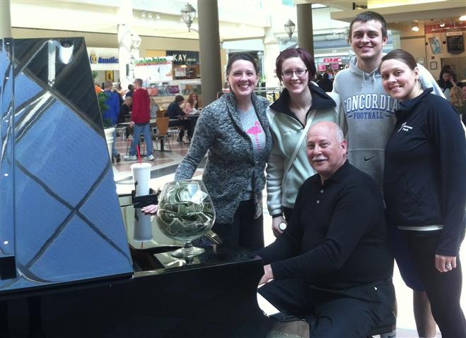 Paul Bahr, longtime piano player at Mayfair mall, got a visit on his last day from his children (from left) Stephanie Bahr, Katie Wheelan, Mike Bahr and Kim Duran.