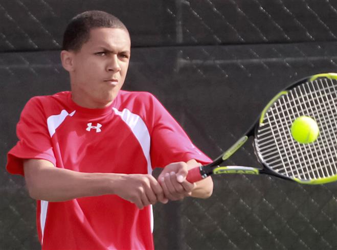 Wauwatosa East’s Jordan Crump connects on a backhand shot as he battles Wauwatosa West’s No. 2 singles player Adam Carlson on May 7.