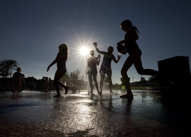 Youngsters cool off in the splash pad at the Hart Park playground during a 2012 Tosa Tonight concert.