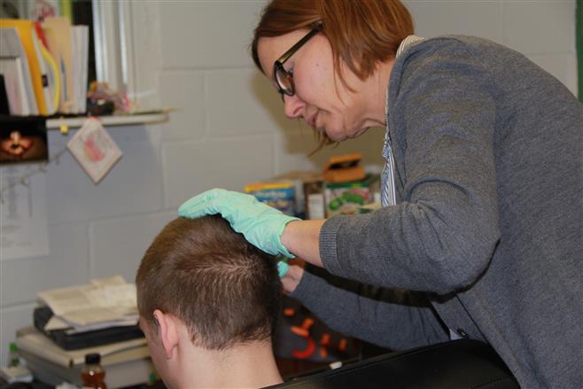 FTA member Barb Hayes-Dineen helps out in the makeup room at Wauwatosa East.