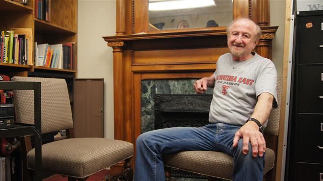 Tom Thaney sits in his office, which is being cleaned out in preparation for the new theater director. He taught for 50 years.