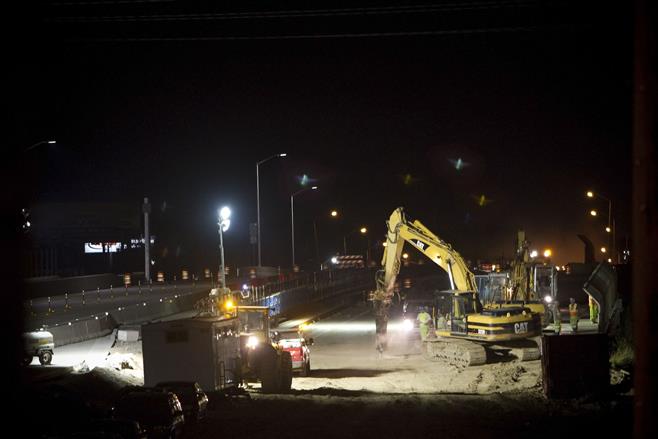Construction equipment is seen in the Highway 100 overpass over I-94 late Friday night, July 18, in Wauwatosa. The Zoo Interchange was closed at 11 p.m. Friday and remained closed until 5:30 a.m. Monday.