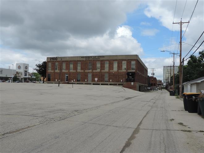 The city has not yet approved the plans to replace this office building and adjoining parking lot at 2100 N. Mayfair Road with an apartment complex.