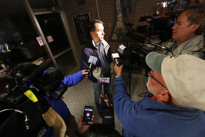 Wiiconsin Governor Scott Walker talks with members of the media after casting his ballot at Jefferson Elementary School Tuesday, Aug. 12, in Wauwatosa.