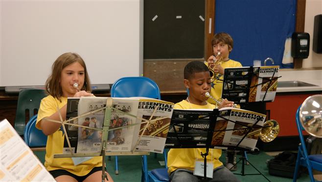 Nadya Mahdasian (left), Nathan Lynn and J.T. Foti (back row) practice trumpet during the summer Beginning Band Blast Off program.