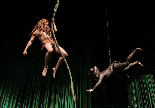 Tarzan (played by Luke Mizer) swings from vines in the jungle to elude a leopard (Madison Debord), as the Wauwatosa East High School drama department rehearses its energetic stage musical, "Tarzan." The show opens May 1.
