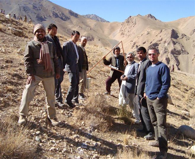 Schmitt (right) stands with local men while working on a watershed project in Bamiyan, Afghanistan. He is a Tosa native.
