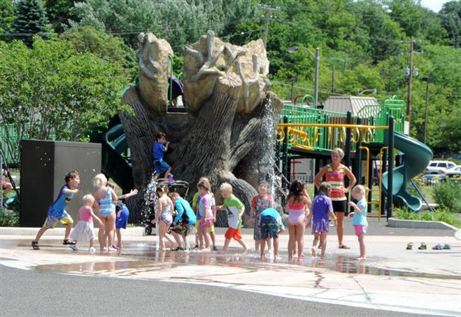 Kids frolic in the splash pad area of Hart Park. Parts have been ordered to automate the water controller.