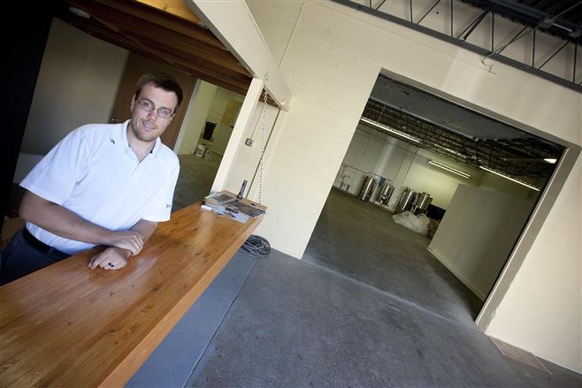 Andrew Dillard is seen in what will be the public area of a brew pub he is building in an industrial building at the intersection of 62nd and State streets.