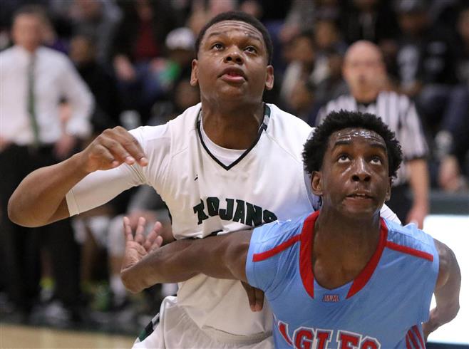 Wauwuatosa West’s Javaree Jackson battles with Morse Marshall’s Cedric Armstrong for a rebound at West on March 4. Tosa West lost the regional semifinal battle.