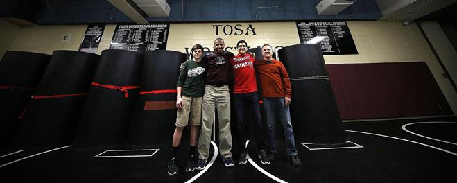 Wauwatosa West/East wrestlers Cole Acker (left), Zewdei Gebremedhin (center) and Norberto Pliego and coach Kent Morin join together for a photo. Gebremedhin is known as the “heart and soul” of the team.