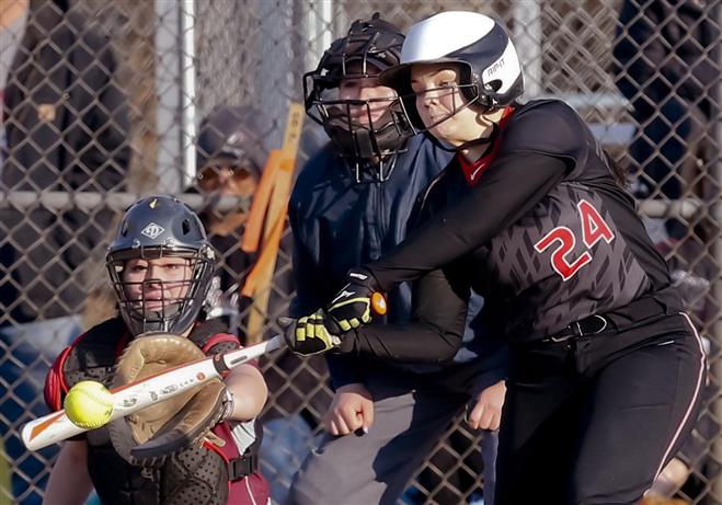 Wauwatosa East’s Natalie Yahn belts an RBI single in the fifth inning of the Red Raiders’s game with visitng Menomonee Falls on April 14. The Red Raiders lost, 12-2.