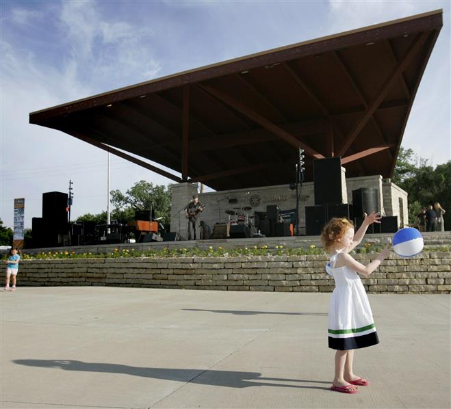 Ellory Bordini, 4, plays while Peter Mulvey performs during a Tosa Tonight Summer Concert at the Rotary Pavilion at Hart Park in 2013. The outdoor concerts begin this season June 15.