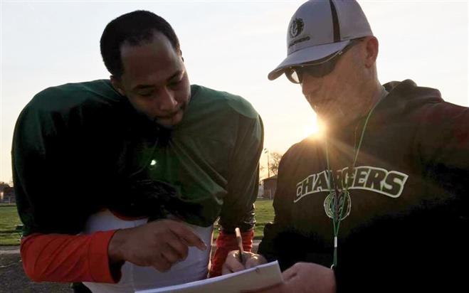 Milwaukee County Chargers head coach Scott Bolin and newcomer Paul Robertson talk over defensive coverages. The Chargers are part of the Mid-States Football League and will play their games at Hart Park. They are taking the place of the Wauwatosa Spartans, who folded in 2014.