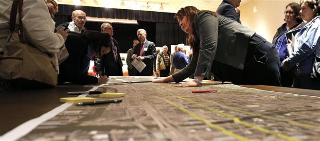 Milwaukee County Executive's Office Public Relations Repesentite Claire Zautke explains a proposed new bus rout in the Zoofairi Center during a public meeting regarding a proposed new public bus rapid transit route Thursday, April 14, 2016, in Wauwatosa, Wisconsin.