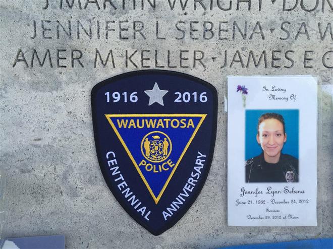A photograph of former Wauwatosa Police Officer Jennifer Sebena and a patch from the department are shown at the National Law Enforcement Officers Memorial in Washington.