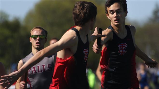 Wauwatosa East’s Adam Schell (rear) hands off to teammate Andrew Casey during the 4x800 relay on May 17 at the Greater Metro Conference Championships at Menomonee Falls.