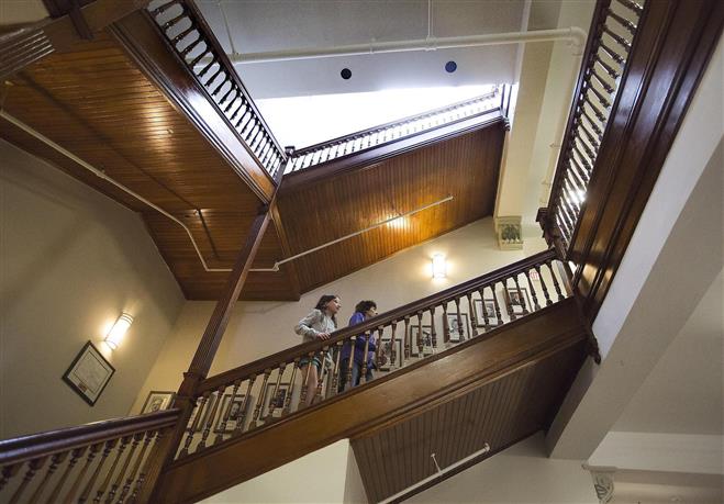 Isabelle Schmitt and her mother Bridget, walk up the staircase at the Eschweiler Administration Building during the 2014 Windows into Wauwatosa Tour on June 21. This is their second year on the tour and the hope to volunteer next year.