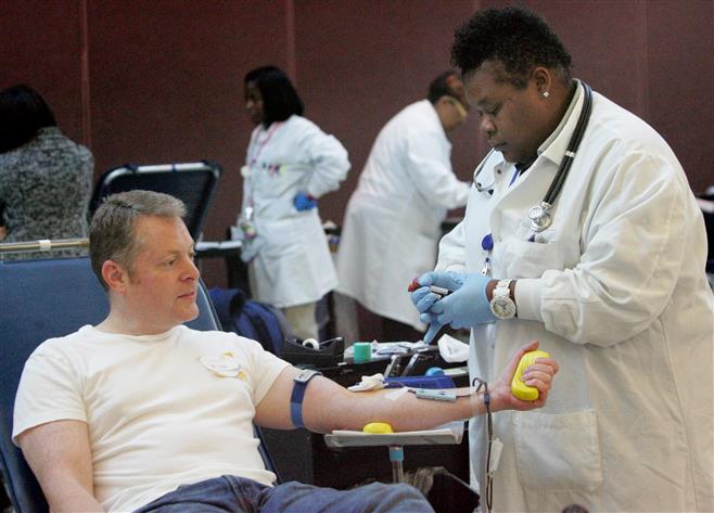 Artise Thompson of the Blood Center works with Mike Reed of Pewaukee on a donation during a 2013 blood drive at the zoo. Many opportunities are scheduled in the coming weeks, including a July 9 session in Wauwatosa.