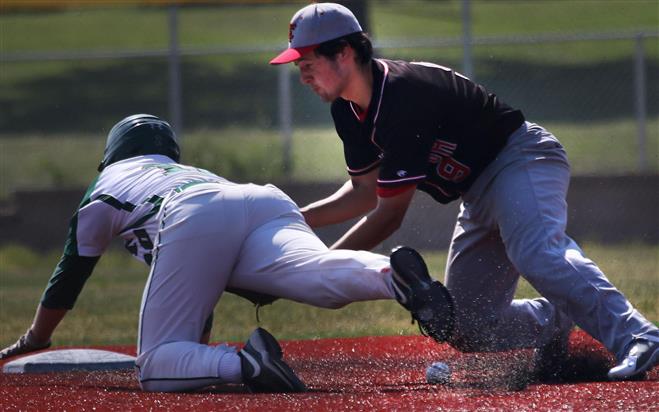 Wauwatosa East’s Spencer Michaelis attempts to tag Wauwatosa West’s Jake Hronek, who stole second base on June 25. East rallied to nip West, 5-4.