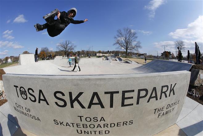 Michael Froemling, 28, of Madison, Wisconsin, jumps into the air at the Tosa Skate Park Saturday, Nov. 7, 2015, in Wauwatosa, Wisconsin.
