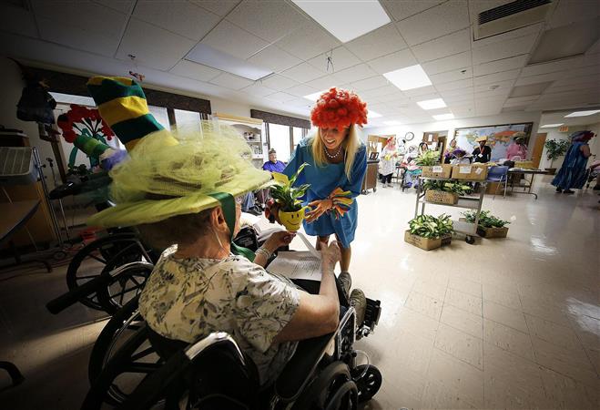 Ninety-four-years-young Rose Marie Letizia is presented with a flower by Melissa Maas at the Luther Manor nursing home Thursday, July 21. Every resident was given flowers.