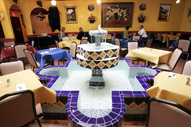 An active fountain beneath a skylight is the focal point of one of the dining areas for La Fuente Restaurant.