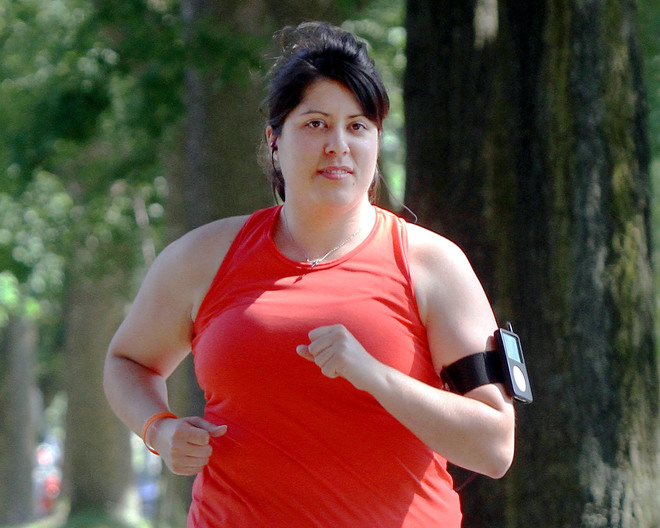 wnt lindner 0707 dh m Preparing for a half-marathon, Mandi Lindner runs along a sidewalk near her home Tuesday, July 5, 2011.