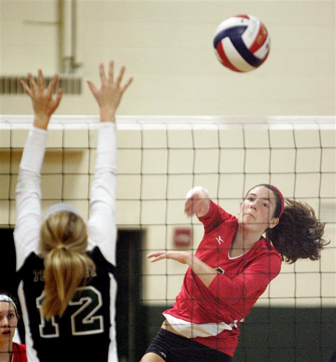Wauwatosa East's Kathleen O'Connell spikes the ball against West.