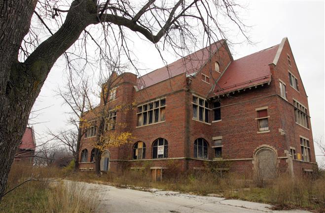 A former administration building, one of four remaining buildings designed by Alexander Eschweiler that are held by the Univeristy of Wisconsin Real Estate Trust, stands solid but in disrepair and vandalized on the Milwaukee County Grounds.