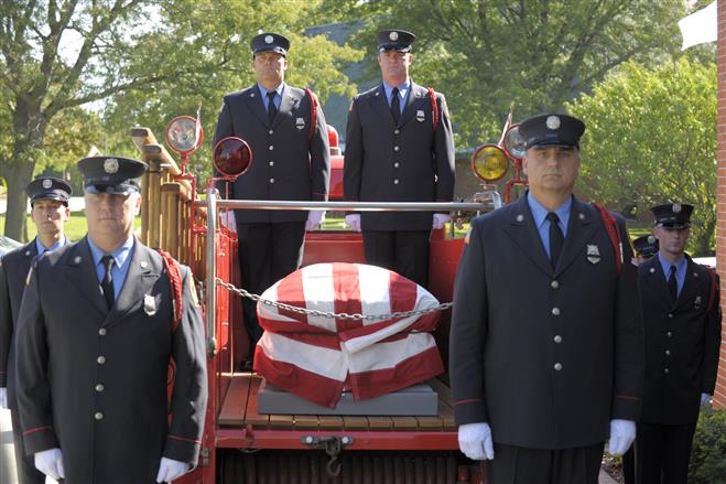An honor guard of Wautosa firefighters stands with the casket of former fire chief Don Bloedorn at the Schmidt and Bartelt funeral home on Monday, Sept. 10, 2012. Ernie Mastroianni photo.