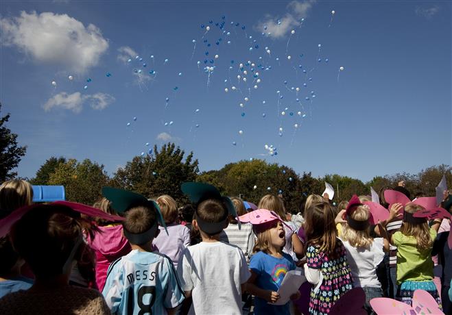 Students, parents and staff look on during a balloon release at Lincoln Elementary School on what would have been Kaylen Birk’s seventh birthday. Kaylen died of a brain tumor Sept. 15, five days before her birthday.