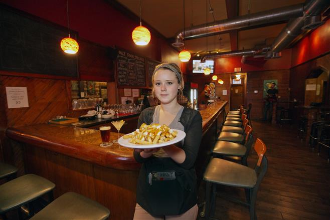 Annie Overholt holds a plate of poutine at Red Dot.