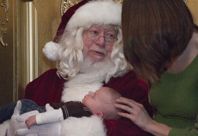 Corbin Budiac, 3 months, waits patiently as Santa chats with his mother, Courtney. A fundraiser held at Dave & Buster’s divided money raised equally among Children’s Hospital and Make-A-Wish Foundation. All vendors donated services and products.