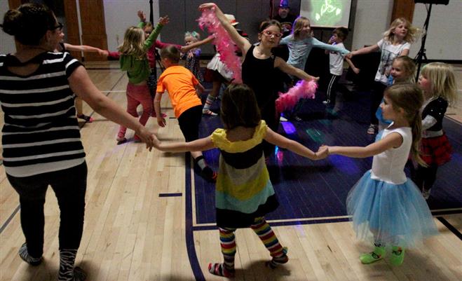 Children cicle up and dance during the first Sock Hop at the Wauwatosa Montessori School on May 16.  