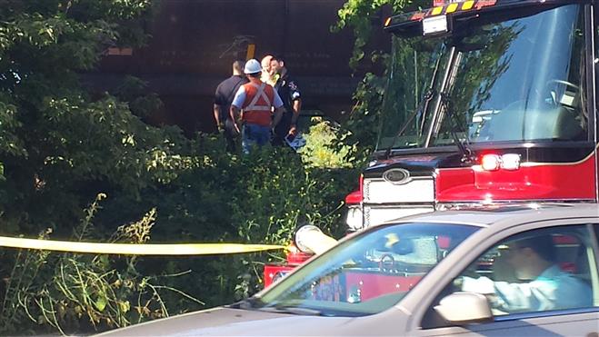 Emergency personnel stand by at the scene of a fatal train-pedestrian accident August 28.