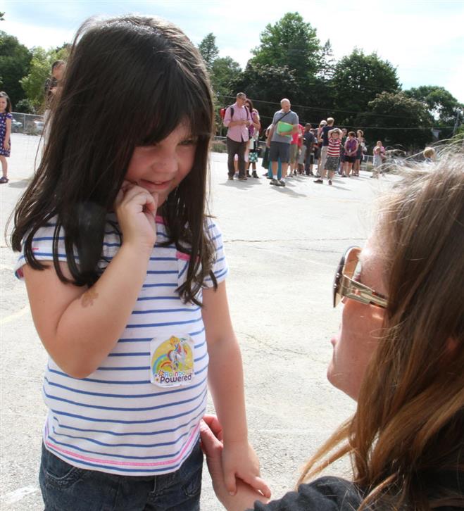 Lucy Kraker is greeted by her summer school kindergarten teacher Kay Kortas during an Ice Cream Social at Jefferson Elementary School on Aug. 26. 